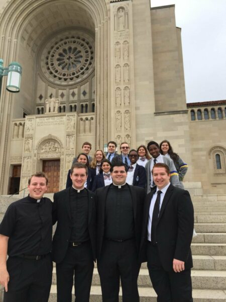 Kellenberg alumni Paul Clores '11, John Crozier '11, Matt Browne '11, Kieran Maelia '13 meet up with Kellenberg students on the diocesan pilgrimage to the National Basilica Shrine.